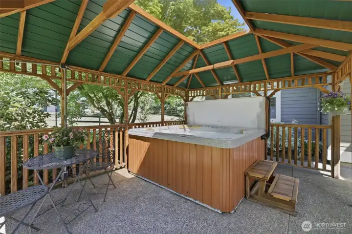 Escape to your own private outdoor sanctuary featuring a covered gazebo and relaxing hot tub, perfectly positioned to take in the peaceful surroundings. This inviting retreat offers year-round enjoyment, whether unwinding after a long day, entertaining guests, or enjoying a quiet morning surrounded by nature. Nestled within the property's park-like setting, the gazebo creates a resort-style atmosphere that enhances the home's exceptional indoor-outdoor lifestyle. Escape to your own private outdoor sanctuary featuring a covered gazebo and relaxing hot tub, perfectly positioned to take in the peaceful surroundings. This inviting retreat offers year-round enjoyment, whether unwinding after a long day, entertaining guests, or enjoying a quiet morning surrounded by nature. Nestled within the property's park-like setting, the gazebo creates a resort-style atmosphere that enhances the home's exceptional indoor-outdoor lifestyle.