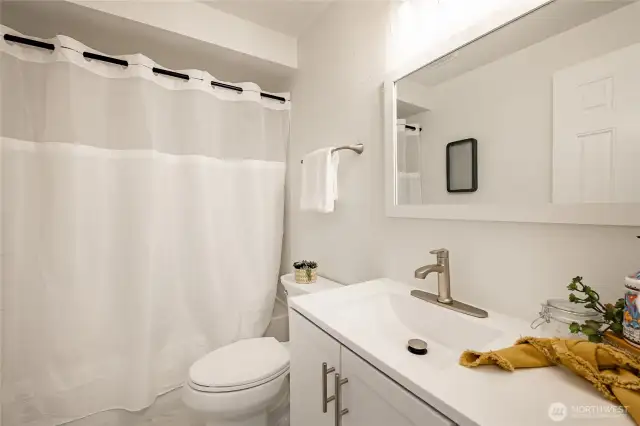 Full bath with new vanity, lights, flooring and shower