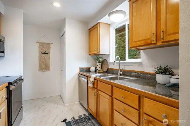 Large kitchen with granite countertops, hardwood cabinets and room for everything.