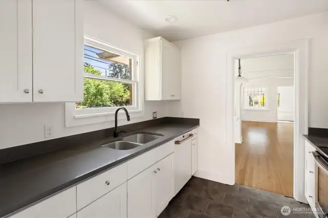 Quartz countertops, updated appliances, tile flooring.  This window in this room is original, one of the few that has not been replaced.