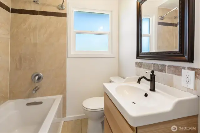 Updated main floor bathroom with huge cabinet above sink.  Hallway has linen closet next to bathroom.
