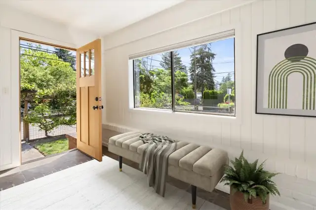Enter into the enclosed, sunny front porch.