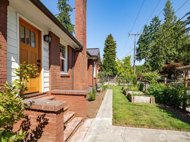 This is the south side of the house, with raised garden beds and a back gate to the parking area on the east side of the property.