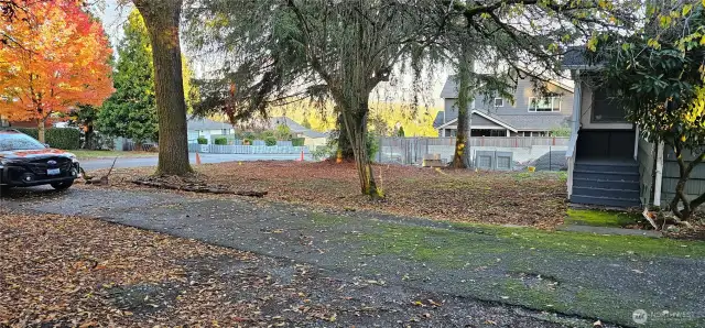 Entrance to the long and wide driveway and Spacious front yard.