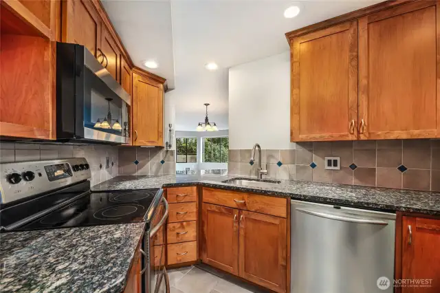 Pass thru to dining area with bar seating  Stainless appliances:    Frigidaire Professional Series side by side refrigerator/freezer and dishwasher  Frigidaire Gallery Series Stove  Frigidaire Microwave, New in Feb 2025  Recessed lighting / recycling station (pull out from under sink) / ceiling cabinet trim