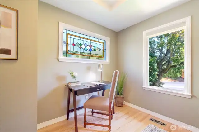 Across the entry from the Living Room, find this Den with a picture window that looks all the way down Raye, where the street sports a literal canopy of trees and greenery.