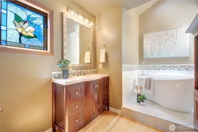 Main floor Bathroom is beautifully updated with a free-standing tub, a skylight to bring in natural light, and a tasteful vanity.