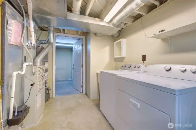 Laundry and mechanical area with a man door to the Garage.