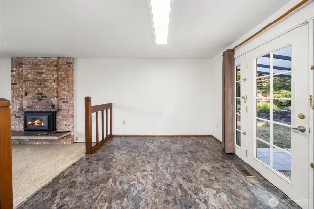 French doors lead to covered patio in backyard