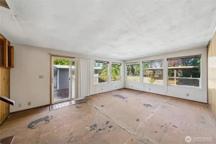 Large bonus/rec area with slider out to the backyard. Needs flooring or carpet