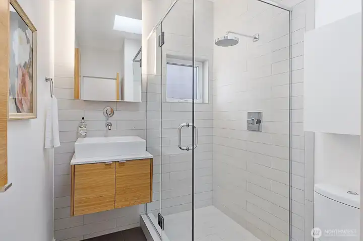 Beautiful guest bath with a gorgeous, glass-surround shower!