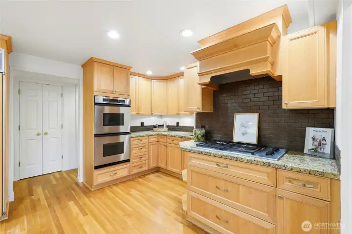 Gorgeous cabinets are accented by tile backsplash and stainless pulls and knobs.