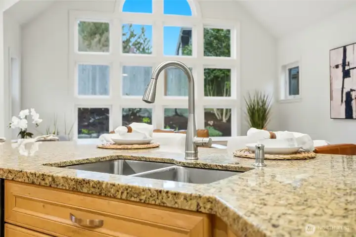 Granite counters abound with 2 stainless sinks, and abundant cabinetry.