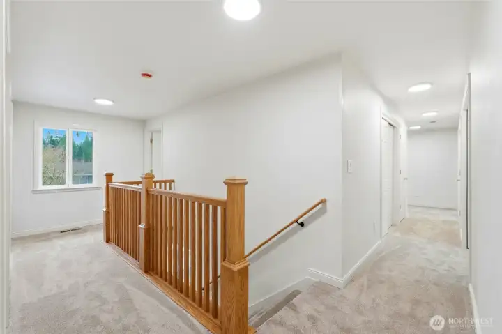 Upstairs landing with 2 bedrooms to the left, and 2 more past the office down the hall to the right.