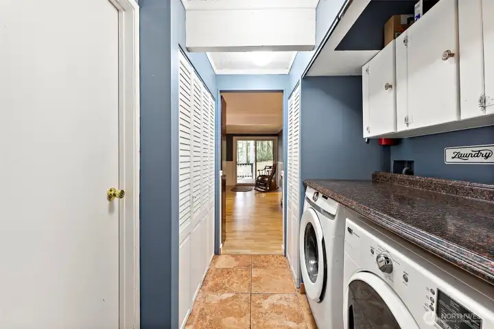Main floor utility room has abundant storage.