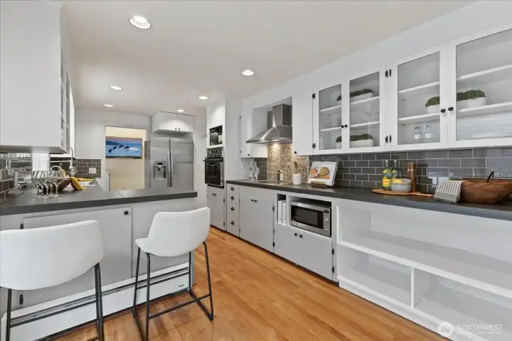 This thoughtful kitchen features an induction cooktop backdropped by gorgeous imported hand-made tiles from Lisbon.