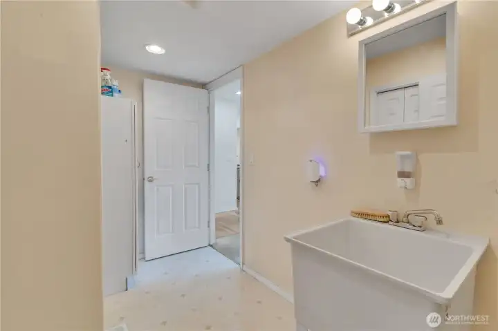 Main floor mudroom off the garage with utility sink and pantry space