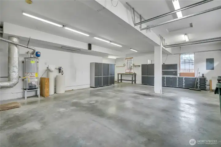 Spacious garage with workbenches and storage cabinets