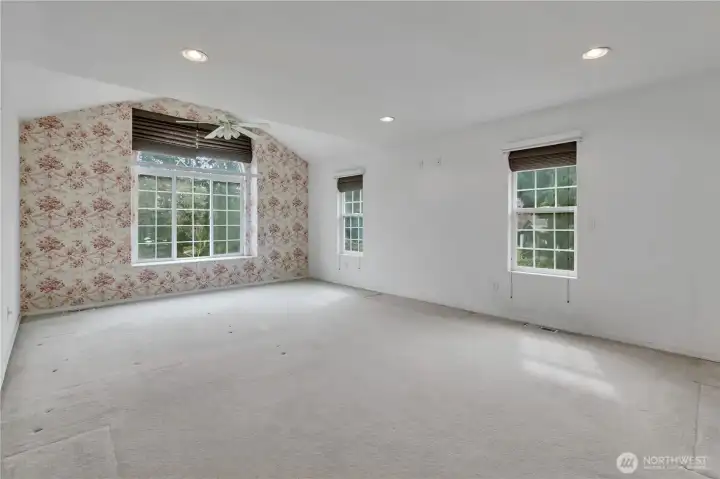 Large primary bedroom with lots of natural light