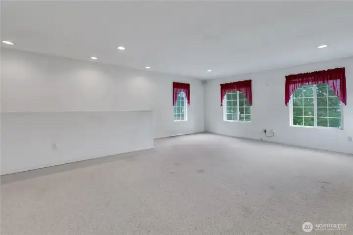 Enormous bonus room or media room. Rear staircase leads down to the family room