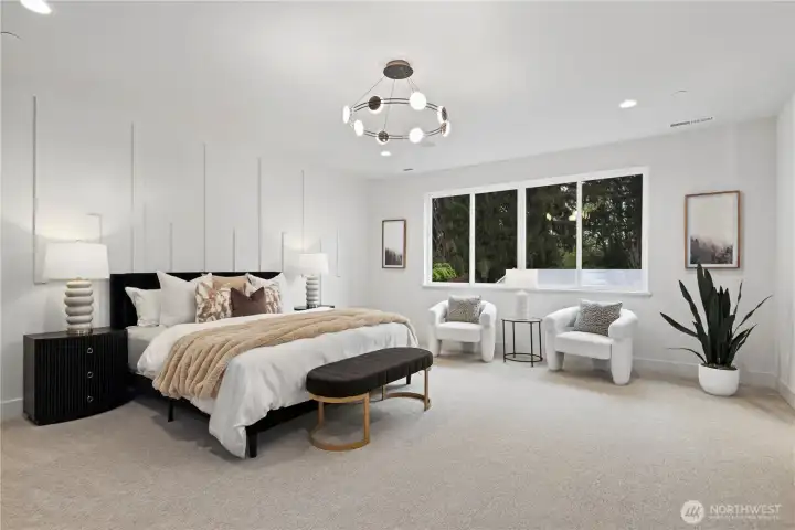 Airy primary suite with oversized windows, chandelier, and refined, calming accent wall design. Prewired for ceiling speakers.