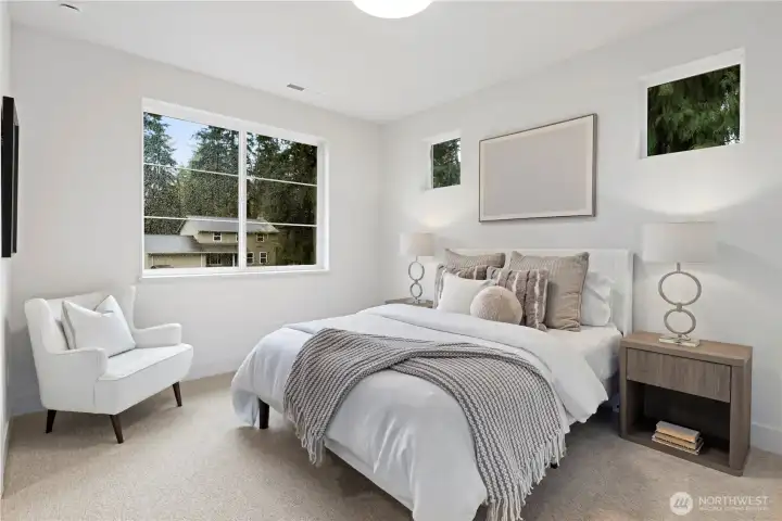 Bright south-facing upper bedroom with room for a queen bed and a desk or sitting area. Walk-in closet includes a high window for added light when picking out clotes to wear.