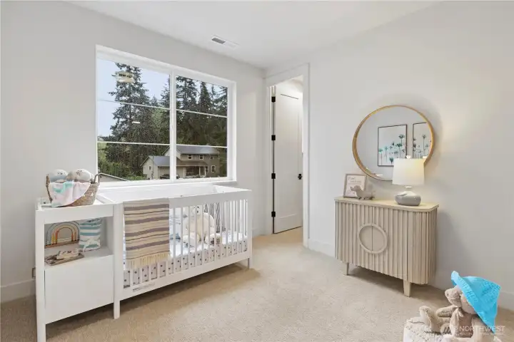 Sweet ensuite nursery, bedroom, or exercise room with large window + walk-in closet.