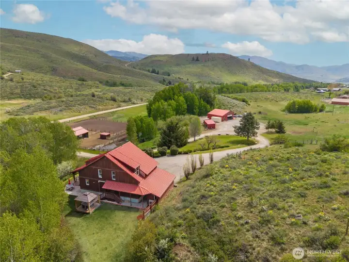 Expansive views and exceptional seclusion define this Upper Rendezvous setting, overlooking equestrian facilities and outbuildings, with a seasonal creek meandering through the landscape—peaceful, quiet, and ideal for stargazing