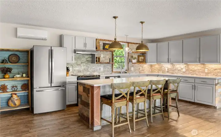 Well-designed kitchen with island seating, custom finishes, and warm wood accents, blending modern function with a relaxed Western aesthetic.