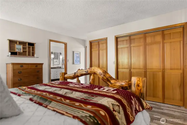 Main floor primary bedroom with warm wood accents, generous closet space, and convenient access to the main floor bath for easy living.