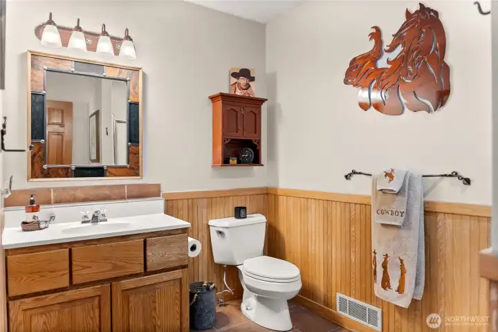 Second-story bath with shower and Western-inspired finishes, blending rustic charm with functional design.