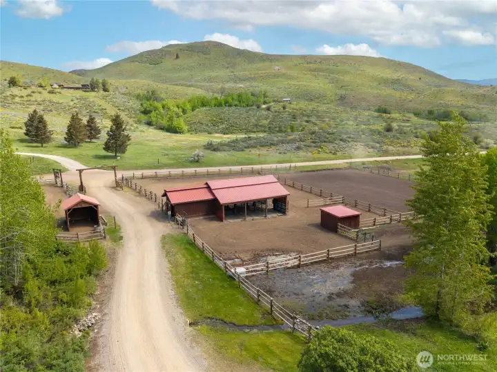 Well-designed equestrian compound featuring a central barn, fenced paddocks, and a full-size arena with good footing, all thoughtfully arranged for ease of use