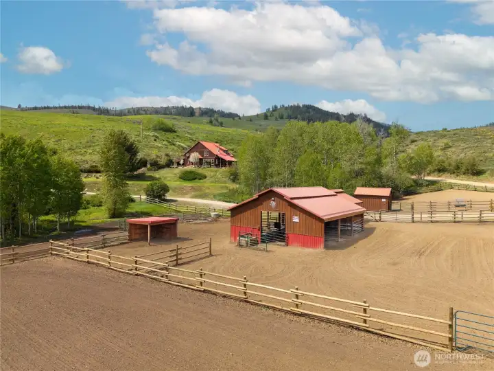 Well-designed equestrian setup with fenced paddocks, barn, and open arena, offering a functional layout for horses, livestock, and everyday ranch use in a peaceful Upper Rendezvous setting.