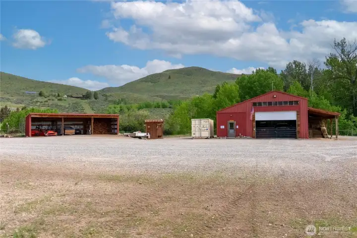 Well-organized outbuildings and covered storage complement the main shop, offering versatility for tools, hay, and recreational gear.  Expansive gravel yard provides easy access, maneuverability circle drive, and room for trailers, trucks, and all your Methow Valley adventures. Charming cedar outbuilding thoughtfully built as an outdoor shower and outhouse, ideal for guests.