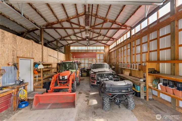 Spacious, fully enclosed barn/shop with wide-span trusses and high-clearance doors—ideal for equipment, vehicles, and all your ranch essentials. Thoughtfully outfitted with built-in workbenches, ample shelving, and generous storage, creating a highly functional workspace for projects, maintenance, and year-round use.