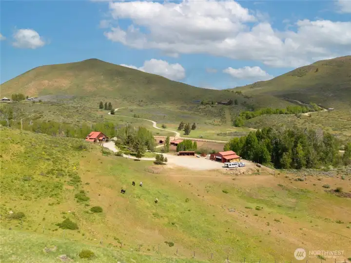 Home on the Range—set in a peaceful, wide-open landscape where rolling hills, grazing pasture, and big sky views create a true sense of place. A serene and private setting, perfectly suited for western living, outdoor adventure, and year-round enjoyment.