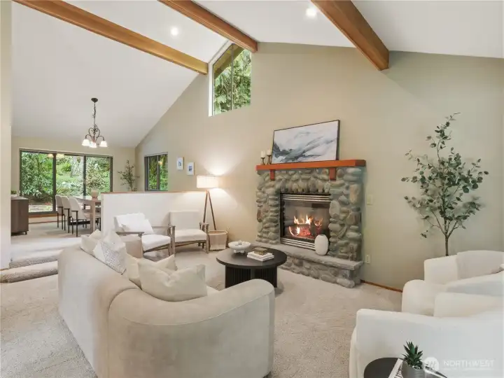 Exposed beams, river rock fireplace, and vaulted ceilings