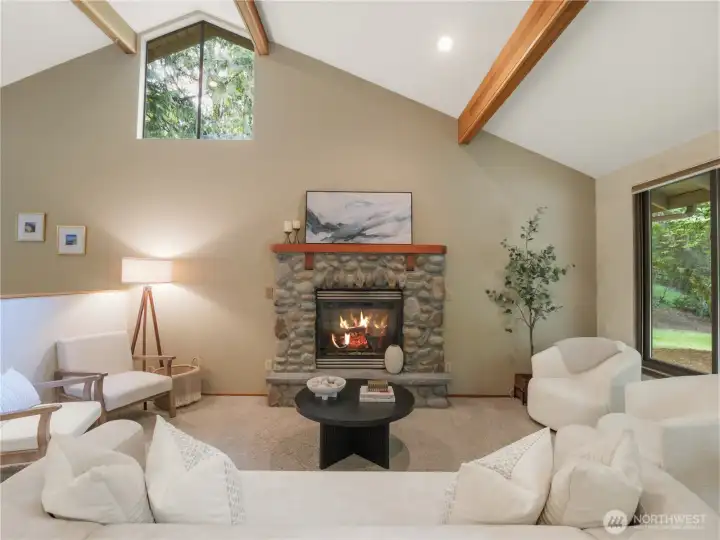 Warm and welcoming living room with river rock fireplace