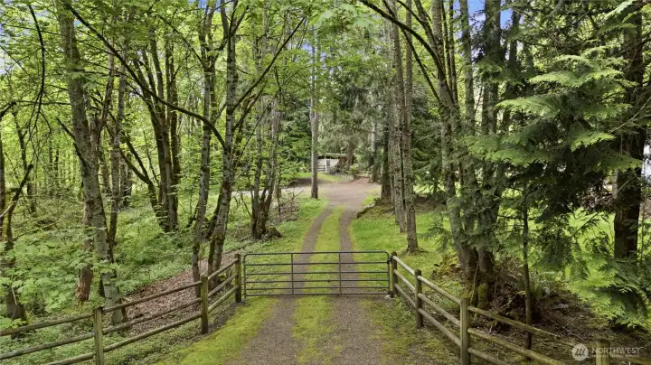 Private and gated 2nd driveway, perfect for all your toys, storage, RV's or to access the detached garage