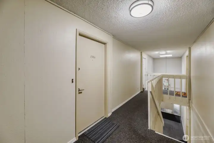 One flight up from the West entrance to the front door of unit 1306.