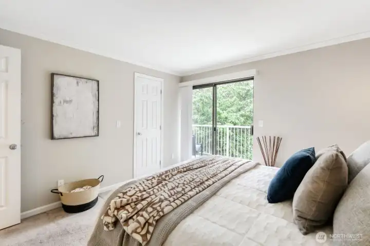 Bedroom with walk-in closet and deck access