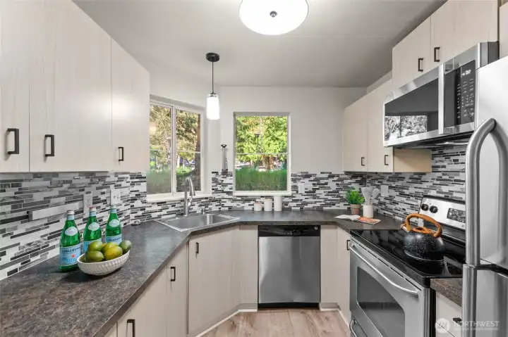 Tiled backsplash with S/S appliances and updated light fixtures.
