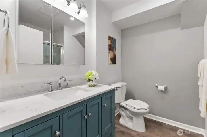 Updated bathroom with new cabinets, flooring and quartz counters.
