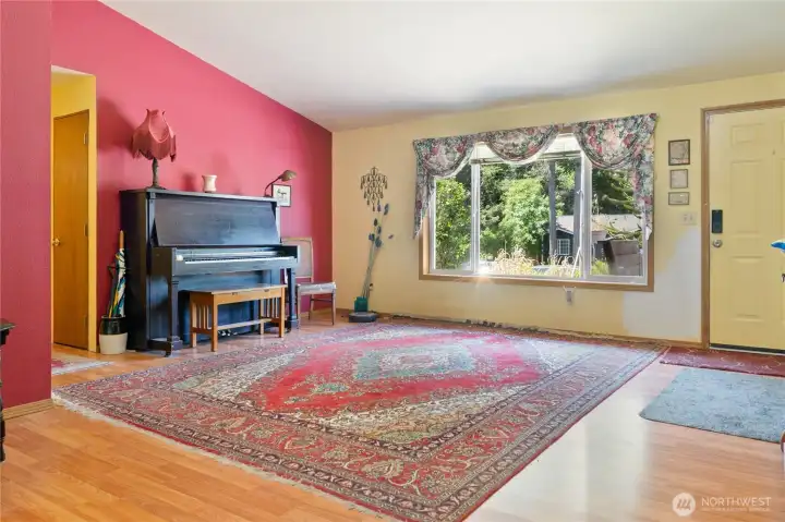 Great room that greets you into the home with a large front window.