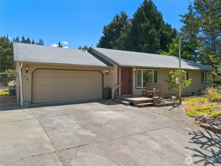 View from the front - driveway, garage, and street parking.