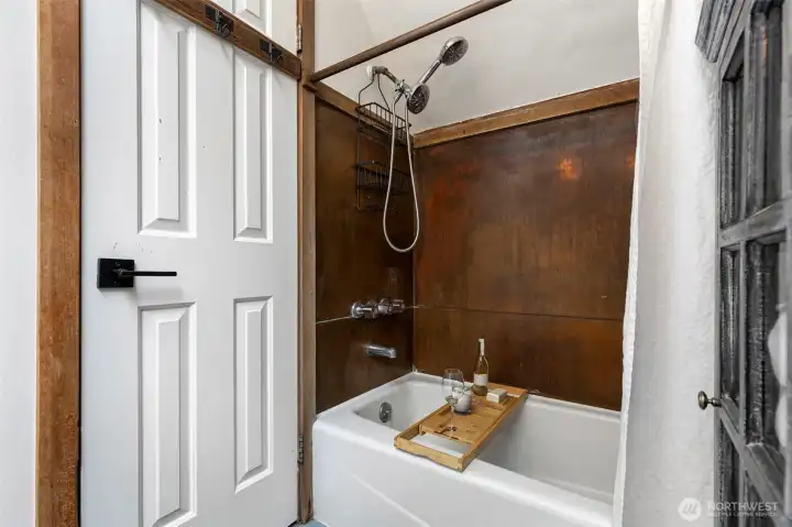 Full bathroom, copper tub surround. Full bathroom, copper tub surround.