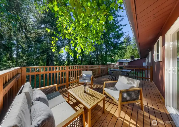 Deck off kitchen/dining area overlooking the lush backyard
