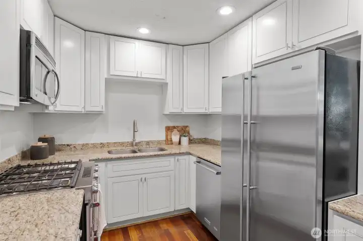Updated kitchen featuring stainless steel appliances, abundant cabinetry, and generous workspace.