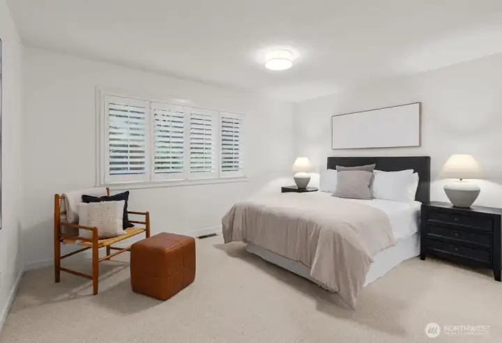 Spacious primary suite filled with natural light and peaceful neighborhood views.