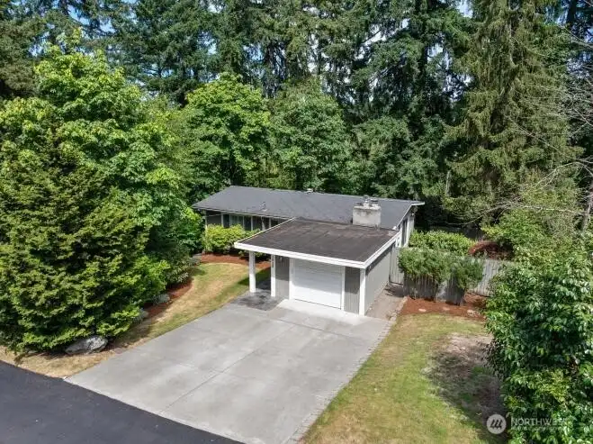 Beautifully sited on a 10,400 sq ft property with mature landscaping, generous outdoor space, and a private backyard retreat.